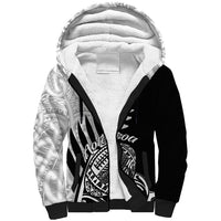 Black sherpa hoodie with white patterned hood lining and tribal Aotearoa front print