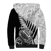 Black and white tribal-print sherpa hoodie with Aotearoa rugby-style graphic on front