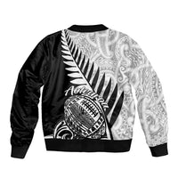 Black bomber jacket with ribbed collar and large Aotearoa tribal graphic on back