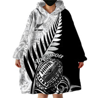 Wearable blanket hoodie with hood, long sleeves, and black-and-white Maori tribal design