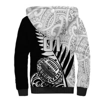 Black sherpa hoodie with bold tribal rugby ball graphic and patterned sleeves
