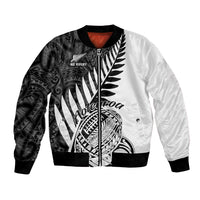 Two-tone black and white rugby bomber jacket with Maori-style tribal front graphic