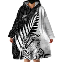 Grey and black wearable blanket hoodie with large Maori pattern and front hood