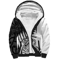 White sherpa hoodie with black Maori-style pattern on sleeves and front graphic