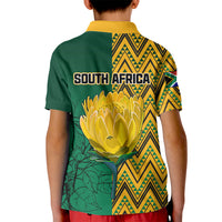 Kids green polo shirt back with South Africa text, yellow protea and patterned panel