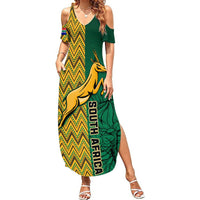 Women's maxi dress with green off-shoulder sleeves and bold chevron springbok graphic