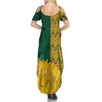 Women's maxi dress with green scoop-back panel and chevron floral hem