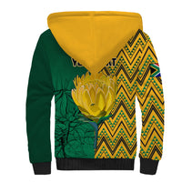 Sherpa hoodie back: yellow hood, green body with zigzag panel and large emblem