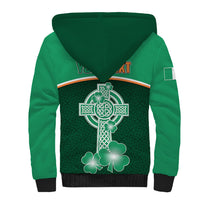 Green sherpa-lined hoodie back with large Celtic cross and clover graphic, black hem and cuffs