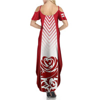 Women’s red and white maxi dress with open back, chevron bodice, large crest print