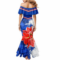 Women’s blue mermaid dress with off-shoulder ruffle and red flower print over white speckle