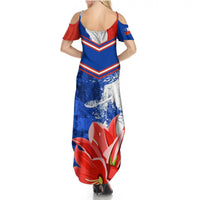 Women’s blue maxi dress, open back with red shoulder accents and large floral graphic
