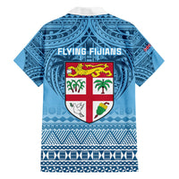 Blue short-sleeve rugby shirt with collar, back crest labeled Flying Fijians and island motifs