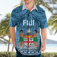 Blue short-sleeve polo shirt with white collar, Fiji Rugby logo and crest artwork