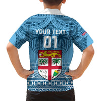 Blue back kids shirt with 'YOUR TEXT' block, crest emblem, and white pattern trim