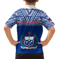 Kids blue V-neck shirt with tribal back pattern, “MANU SAMOA” and shield crest