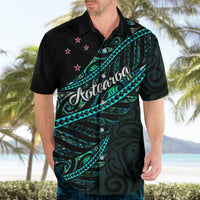 Black Hawaiian-style button-up shirt with teal fern and wave pattern, front view