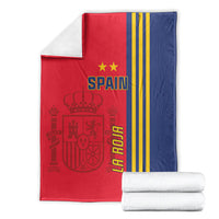 Folded red and navy Spain football blanket with gold stripes and 'SPAIN' text