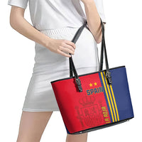 Red and blue Spain-themed leather tote bag worn on shoulder with black top handles