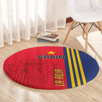 Round Spain carpet with bold Spain text, yellow vertical stripes, and red crest graphic