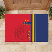 Red and blue Spain football doormat with crest, stars, and yellow stripes on stone tiles
