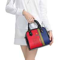 Two-tone Spain-themed shoulder handbag with red front, blue side, and black handles