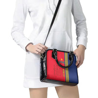 Red and blue tote-style shoulder bag with black trim, short handles, and strap