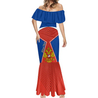 Off-shoulder mermaid dress with blue ruffle neckline, red chevron hem, central crest panel