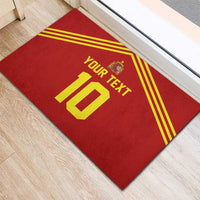 Red rubber doormat on hardwood floor with yellow stripes, Spain crest and custom 10