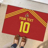 Red rubber doormat on speckled tile with yellow stripes, Spain crest, custom text 10