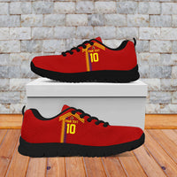Red sneakers with yellow-red stripe, black laces, black tread outsole, on a box