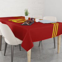 Red football-themed tablecloth with yellow stripes and emblem, draped on dining table