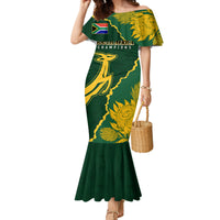 Women’s green off-shoulder mermaid dress with gold floral and rugby-style graphic print