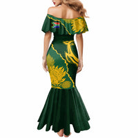 Women’s green off-shoulder mermaid dress with gold floral print and open off-shoulder back