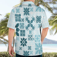 Light teal Hawaiian shirt back on model with floral and palm pattern, short sleeves