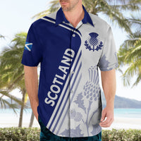 Blue and white short-sleeve button shirt with Scotland text, thistle emblem, floral print