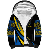 Black sherpa hoodie with blue and yellow patterned sleeves and large front emblem
