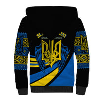 Black sherpa hoodie with blue and yellow crest graphic and geometric sleeve bands