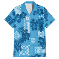 Blue short-sleeve button-up Hawaiian shirt with dark floral and white tapa-style patches