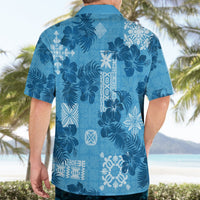 Blue short-sleeve Hawaiian shirt, back view, dark floral with white vertical panel and motifs