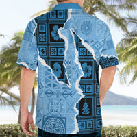 Turquoise Hawaiian shirt back view with dark grid blocks, tiki icons, and map silhouette