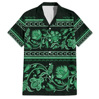 Green Hawaiian shirt, short sleeves, collared button-up with floral ornament print.