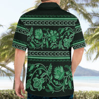 Green Hawaiian shirt back on model, short sleeves, collared with floral ornament print.