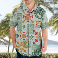 Light green Hawaiian shirt on man, button-front with multicolor tapa quilt and flowers