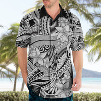 Black and white Hawaiian shirt on model, short sleeves and button-front with floral tribal print