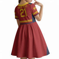 Kids red short-sleeve soccer dress, yellow trim, navy sleeves, back number 21 design