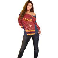 Red off-shoulder sweater with LA ROJA text, crest emblem, and multicolor diamond print