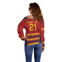 Red off-shoulder sweater with blue yoke, yellow '21' and geometric diamond print