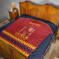 Spain crest quilt on bed: navy blue edges with red center and yellow diamond border