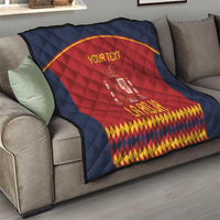 Red-and-blue Spain crest throw quilt on sofa with gold curved border